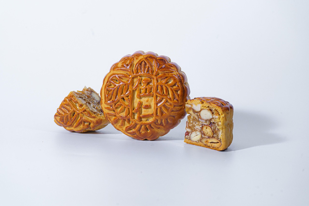 Golden, oven-baked mooncake (bánh trung thu) cut open to show its lotus seed and nut filling