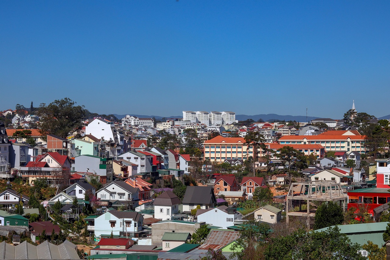 View over the colourful rooftops and houses of Đà Lạt under a clear blue sky