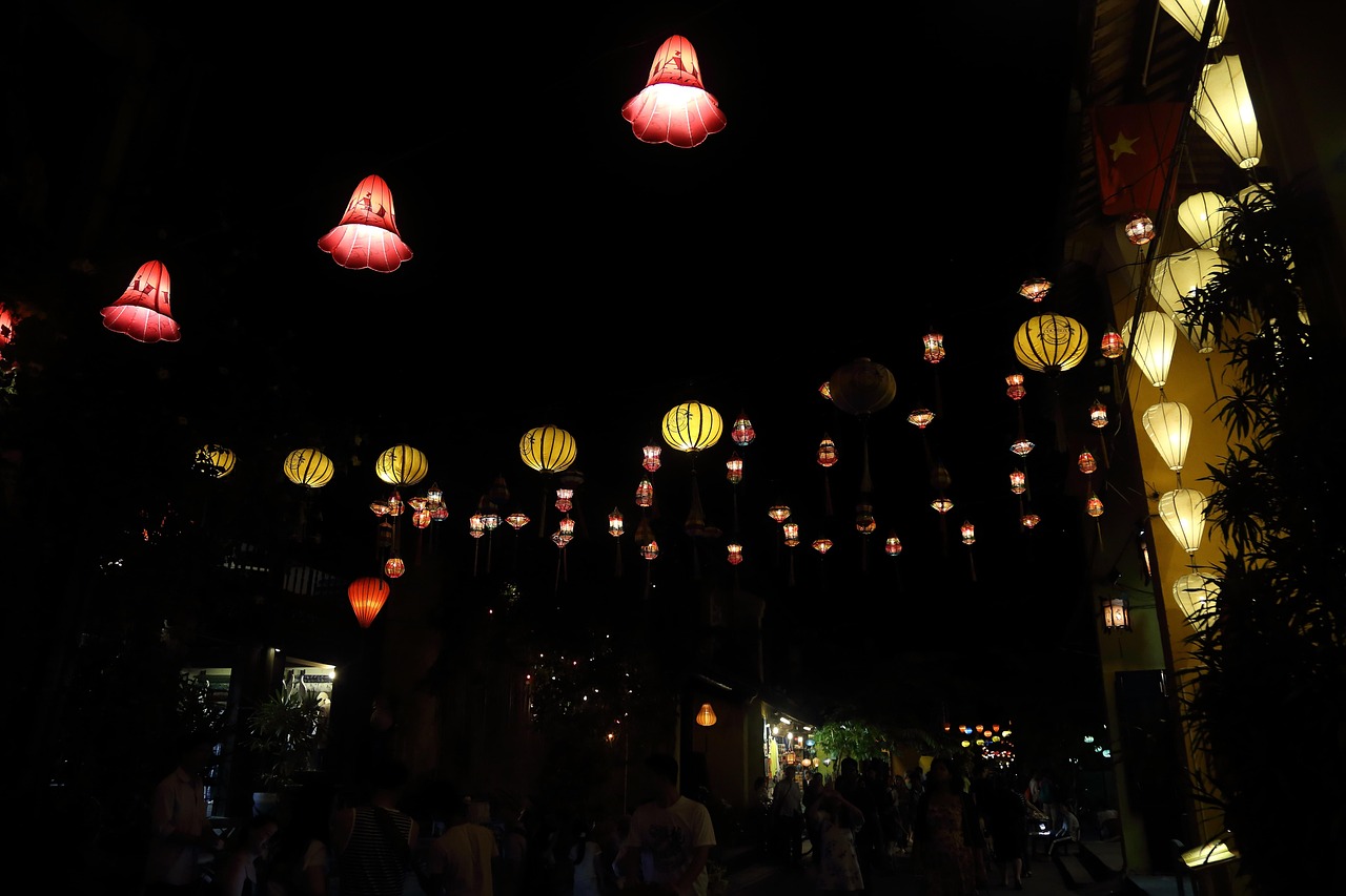 Hoi An old town alley plunged into darkness, lit only by hundreds of silk lanterns strung above the street